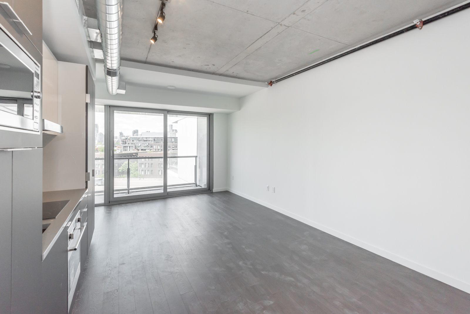 This photo shows the living and dining rooms and also a shot of the balcony.