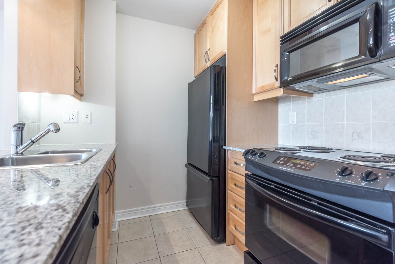 Photo of 100 Hayden Street kitchen, with its so many dark appliances. Same, less, rather, while, yet, opposite, much as, either as a result, hence, consequently, therefore, and in conclusion.