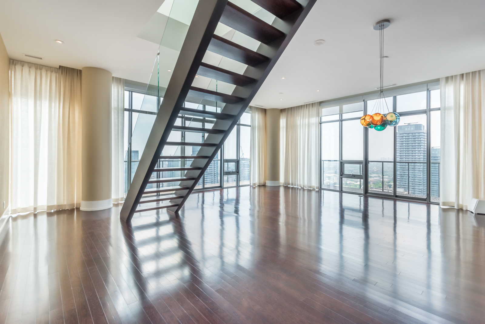 View of 33 Charles Street living room and stairs.