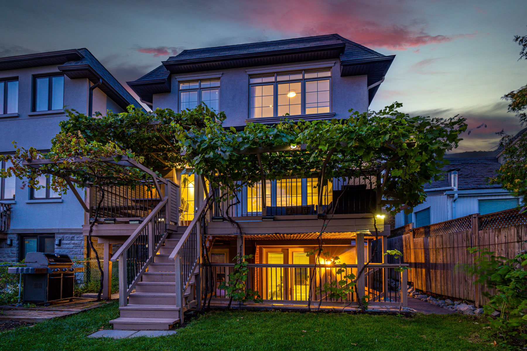 Backyard of 741 Glencairn Ave glowing with light at evening.