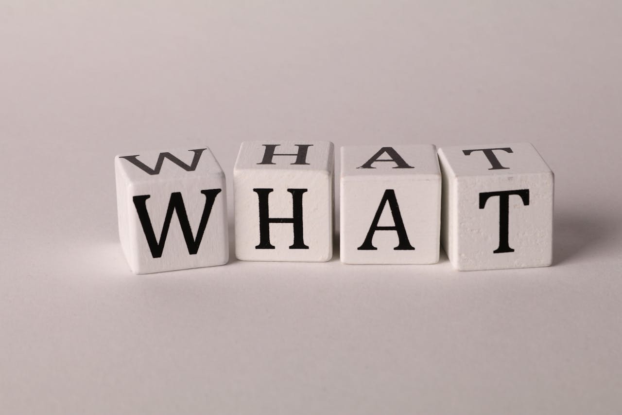 White dice spelling out "WHAT" to answer what is the Vacant Home Tax?