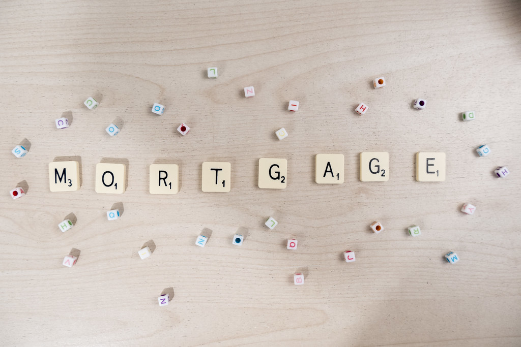 Beige scrabble tiles spelling out word “Mortgage.”