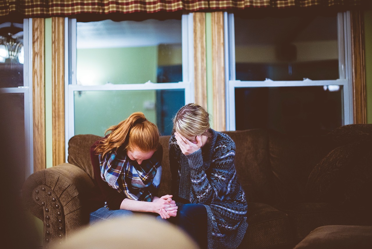 Two women at home looking stressed to show anxiety over Vacant Home Tax,