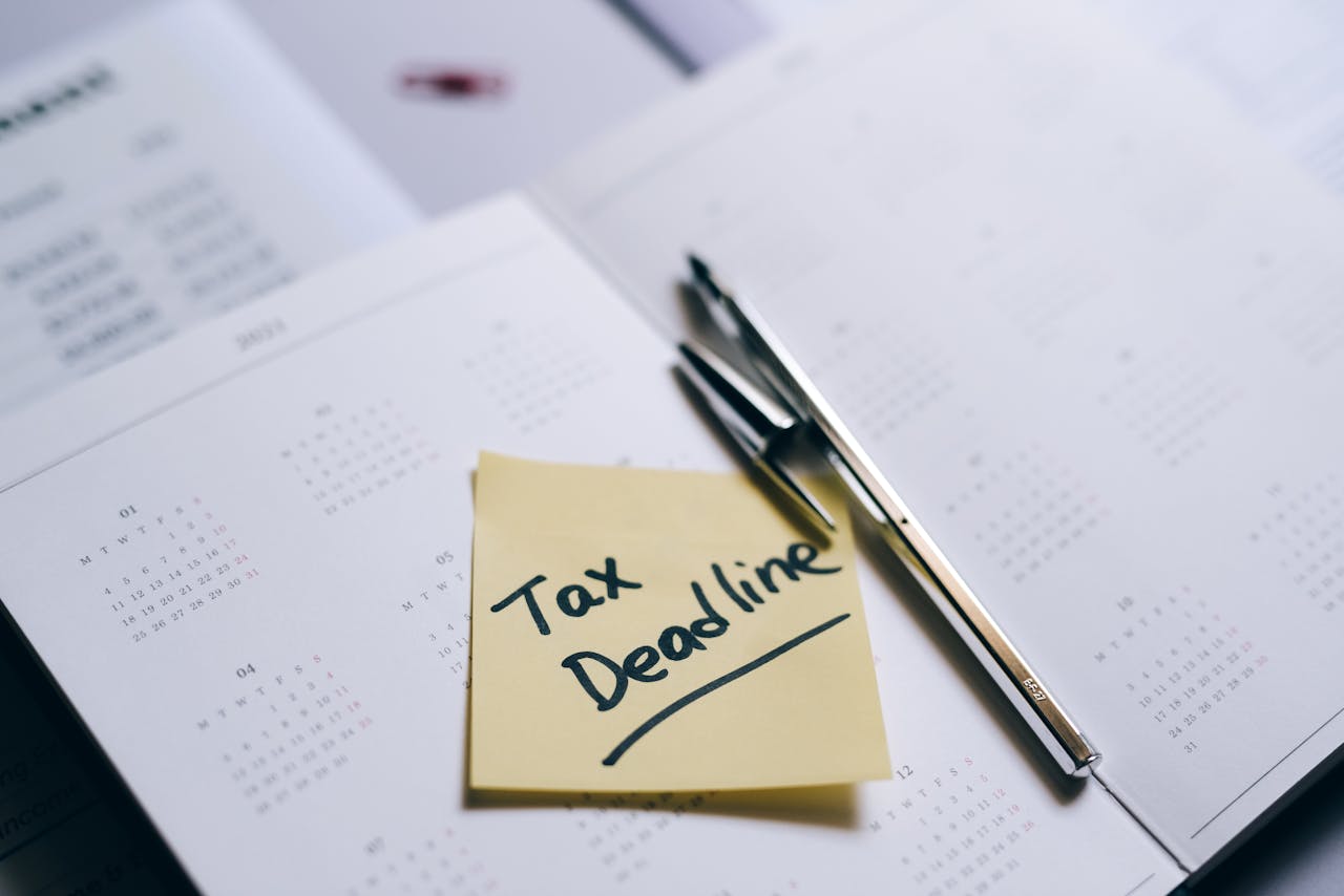 Yellow sticky note with words "Tax Deadline" on notepad to convey Vacant Home Tax deadline.