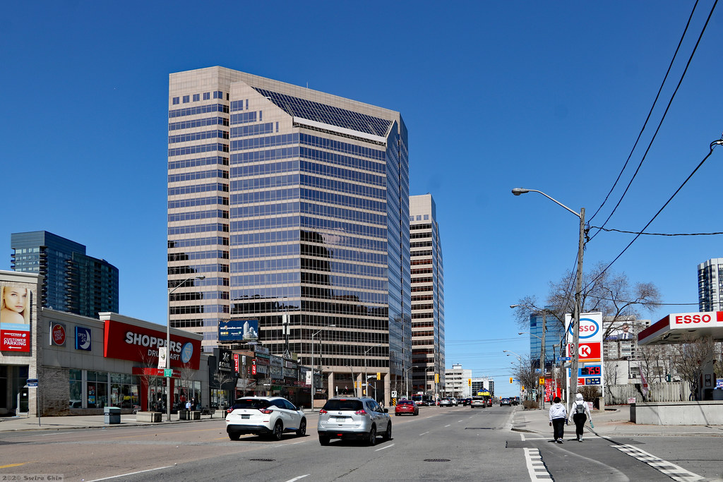 Pedestrians, streets, cars and buildings in York, one of The 6ix areas of Toronto.