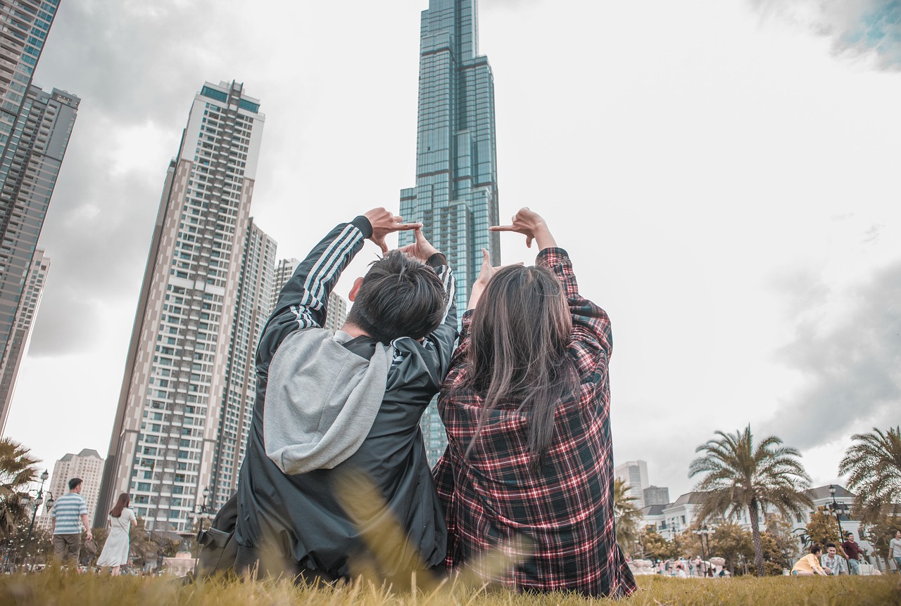 2 young Millennials looking up at condo.