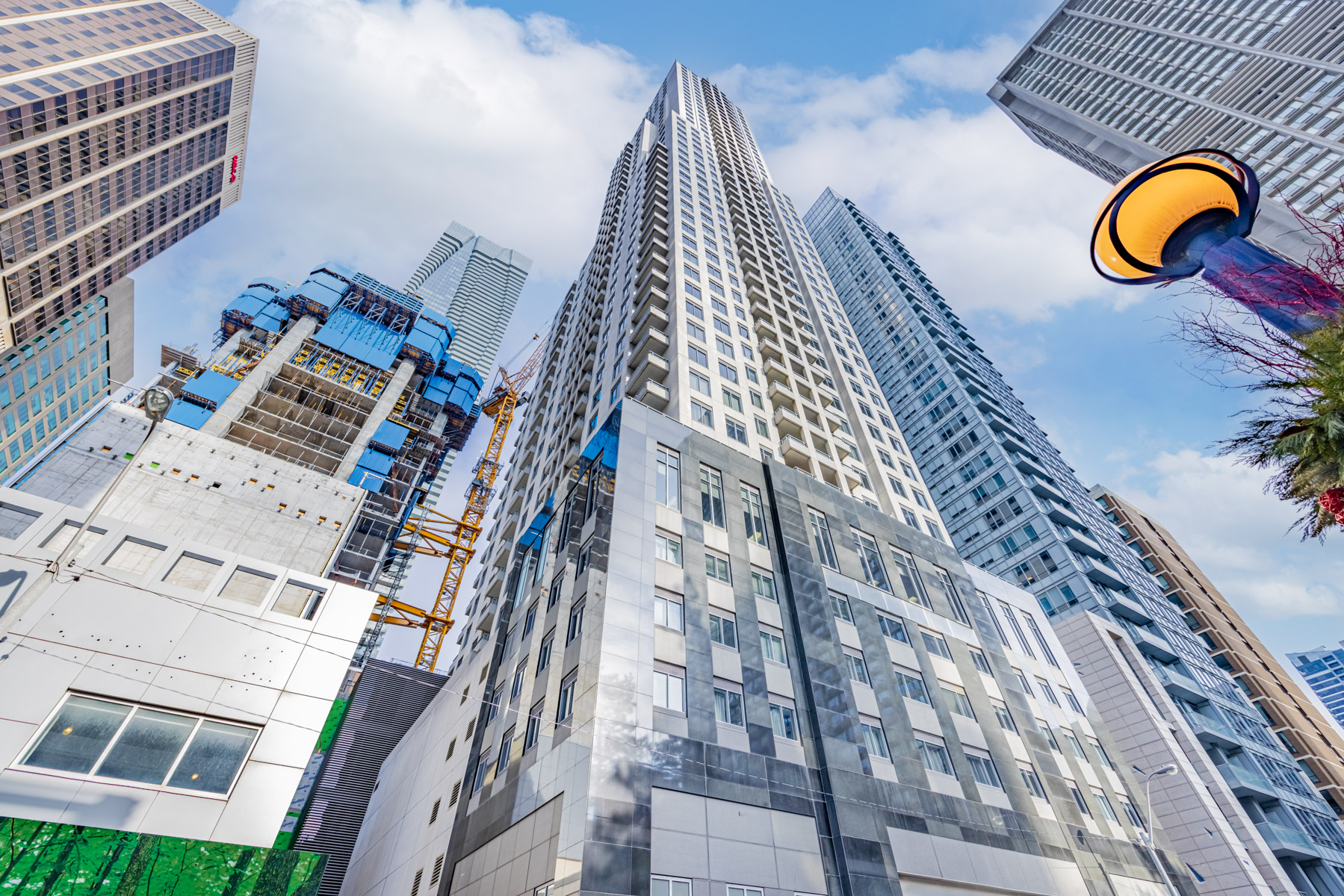 Looking up at 35 Balmuto St or Uptown Residences, a 48-storey Art Deco condo.