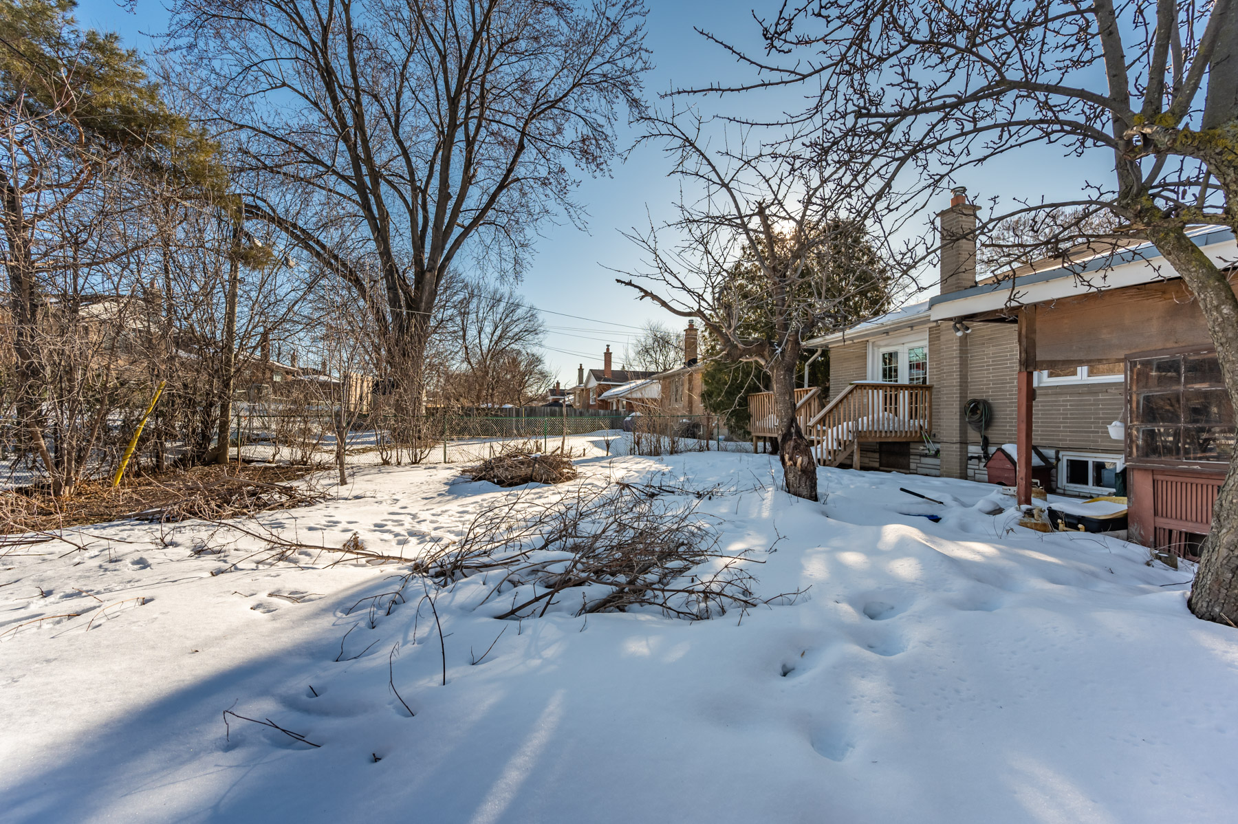 View of trees and snow-covered backyard – 6 Wishing Well Dr.