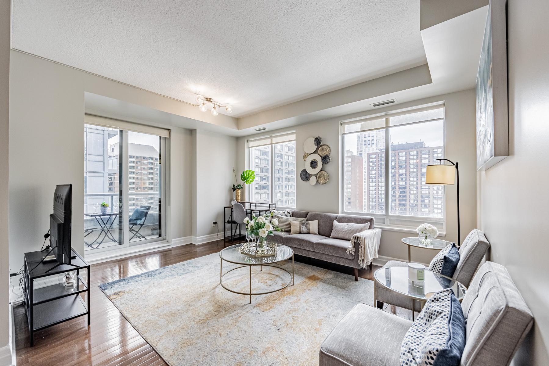 35 Balmuto St Unit 1209 living room lit by 2 windows and balcony.