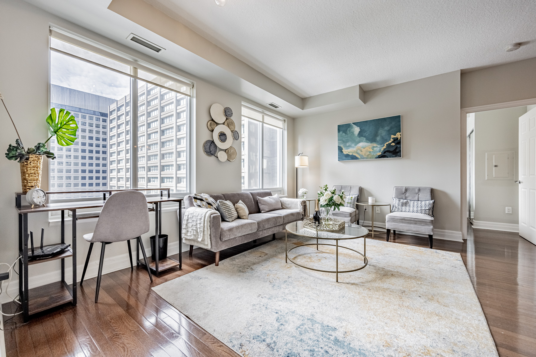 Elegant condo living room with accessories, painting and furniture.