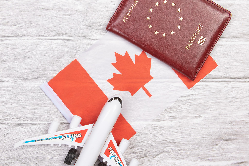 Canadian flag, toy plane and passport to show who is impacted by NRST. 