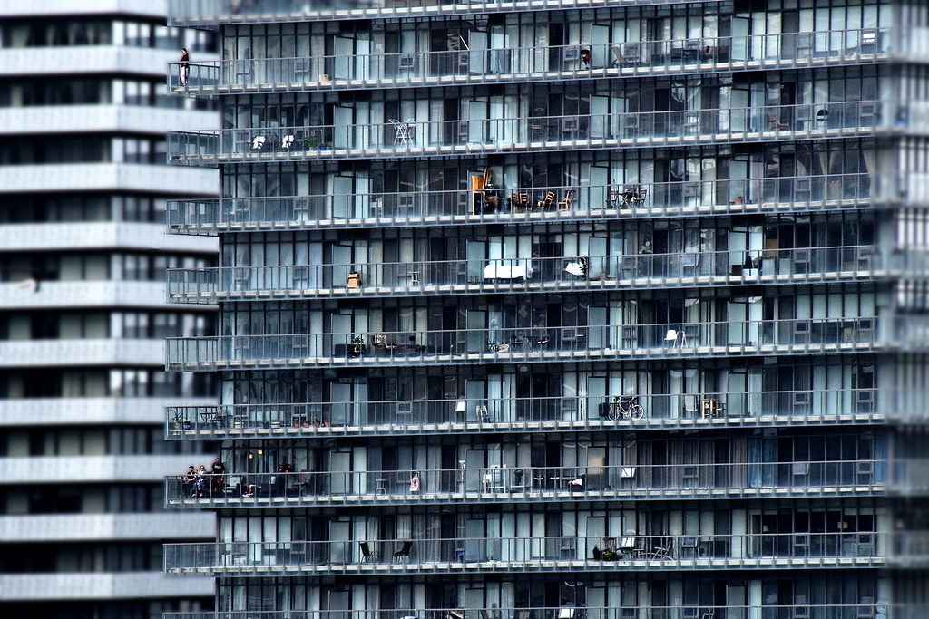 Far view of condo balconies made of bluish glass. 