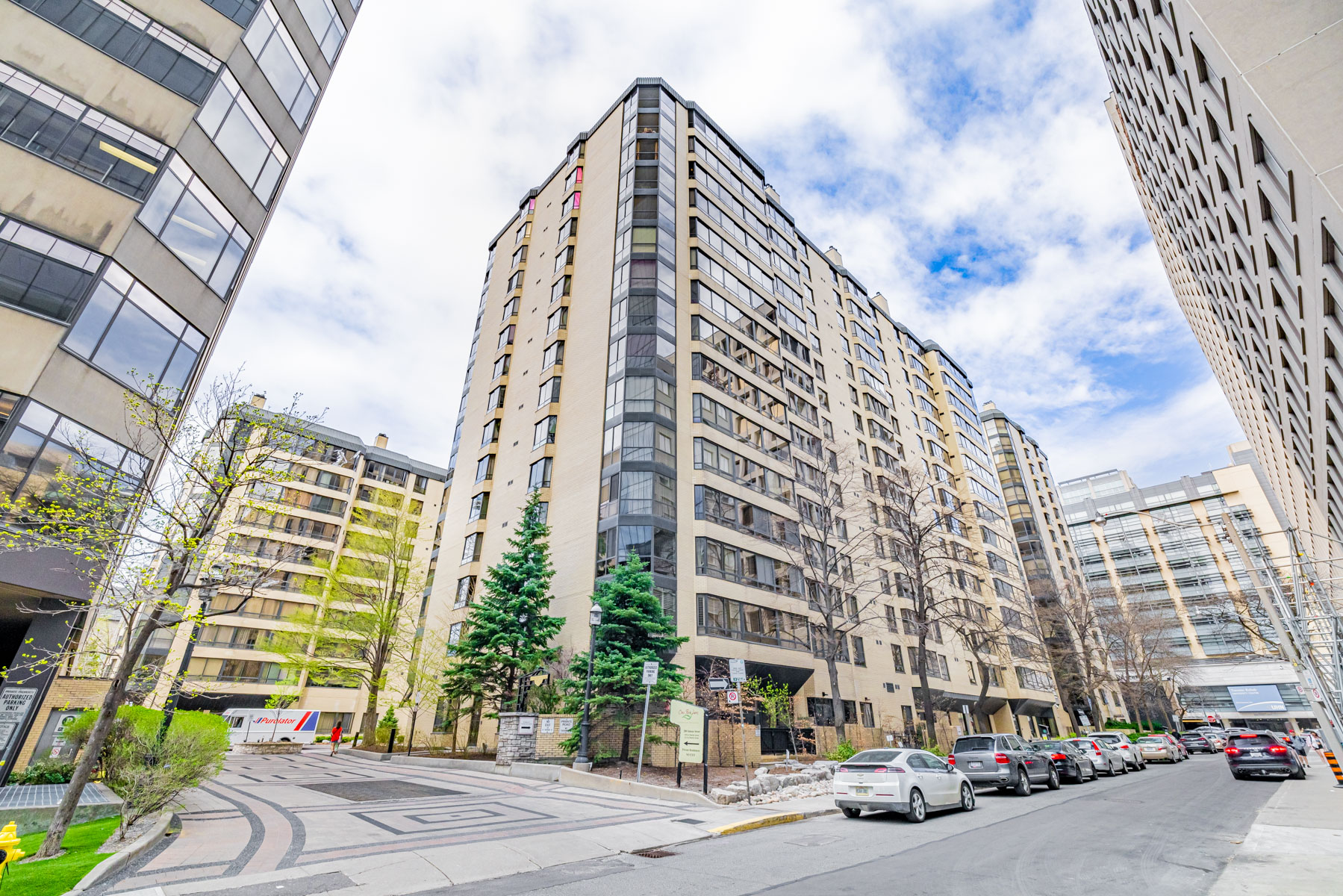 Across the street photo of One Park Lane condo on quiet, tree-lined street.