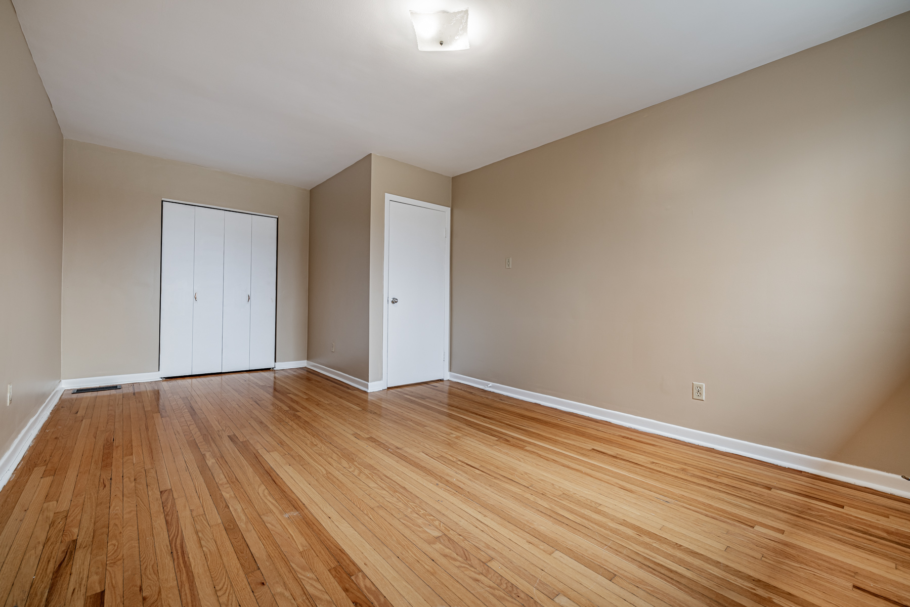 1 Stong Court primary bedroom with hardwood floors and large closet.