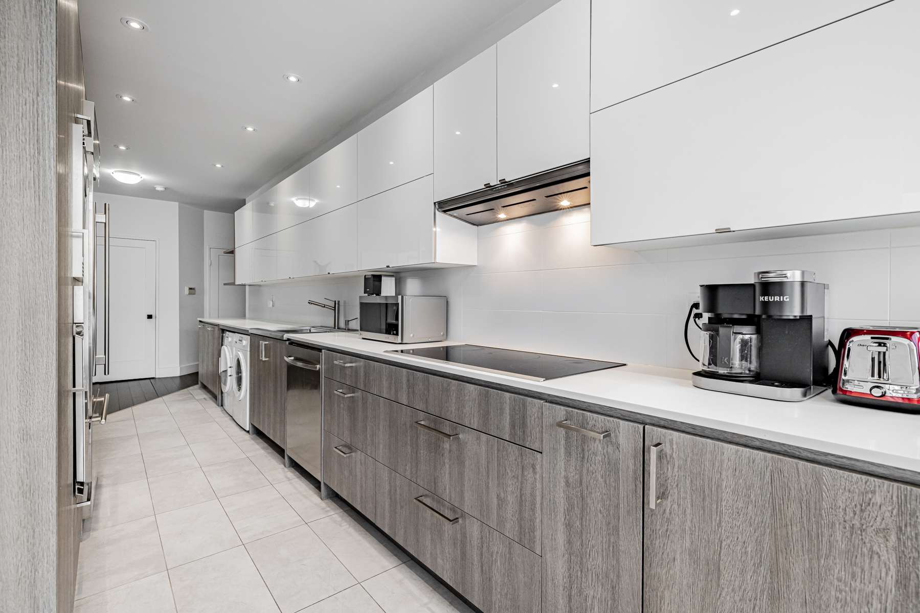 Condo galley kitchen with a lot of storage cabinets and cupboards.