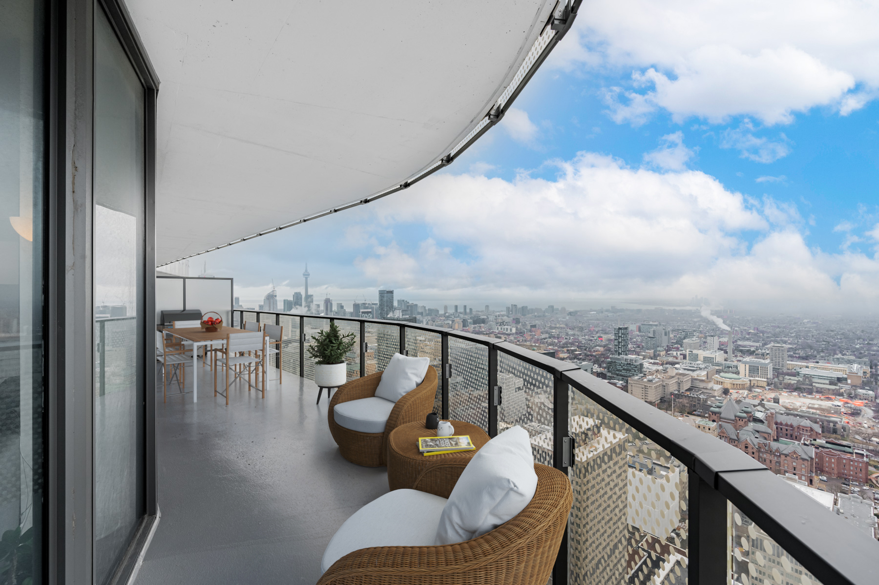 Condo Balcony with grill, table and chairs.