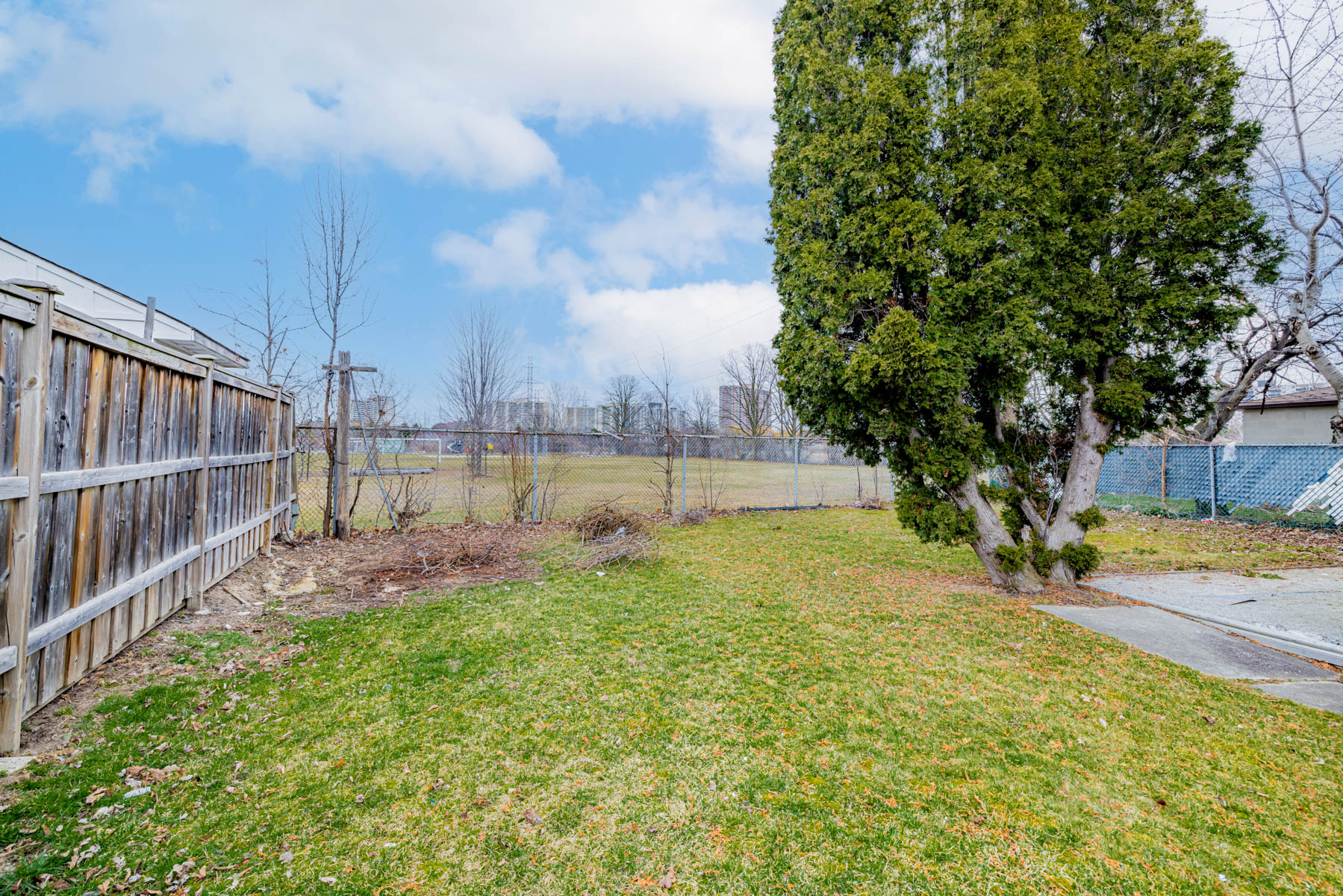 1 Stong Court backyard fence overlooking soccer field of school.