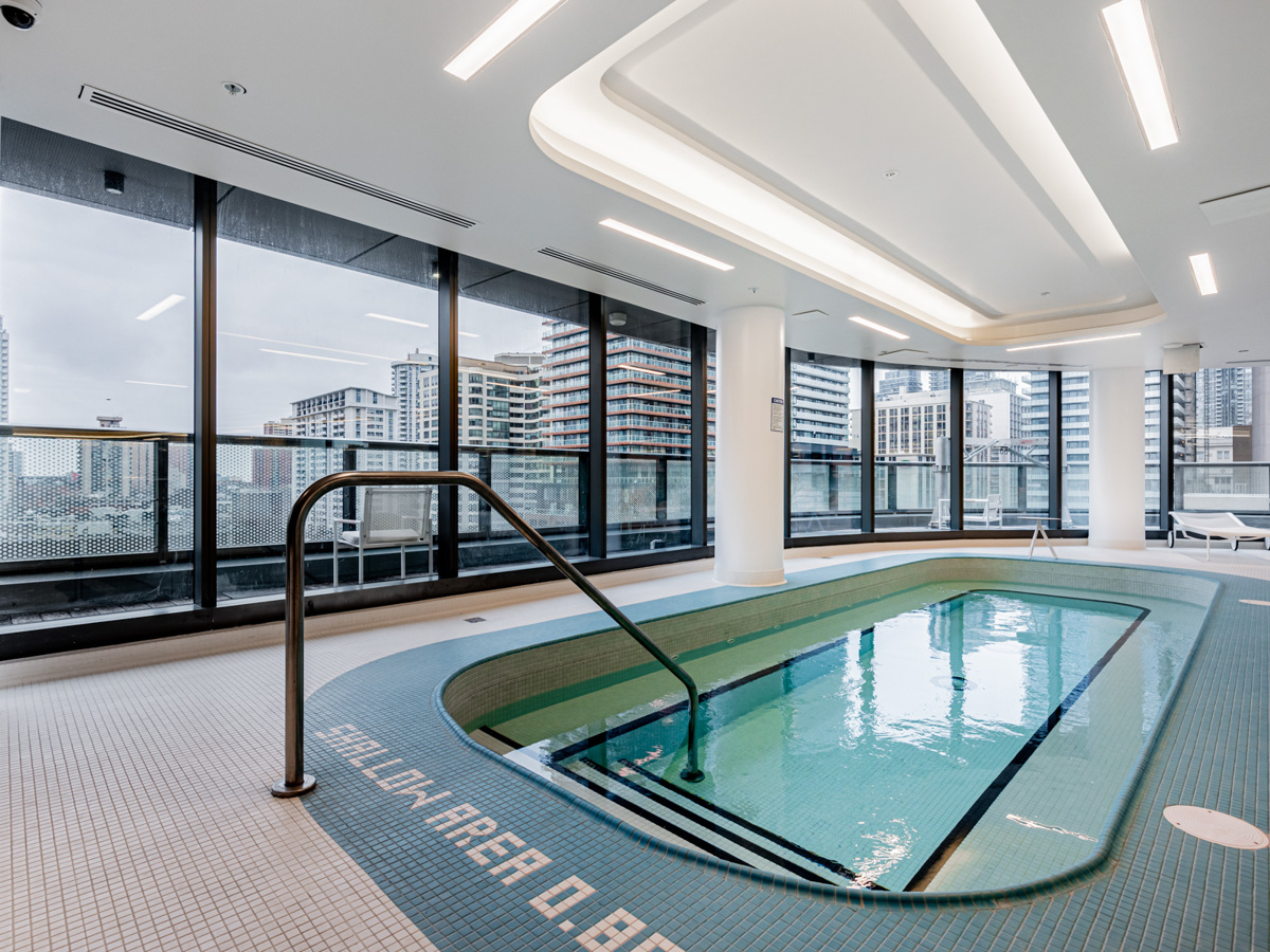 Condo pool with view of Toronto through windows.