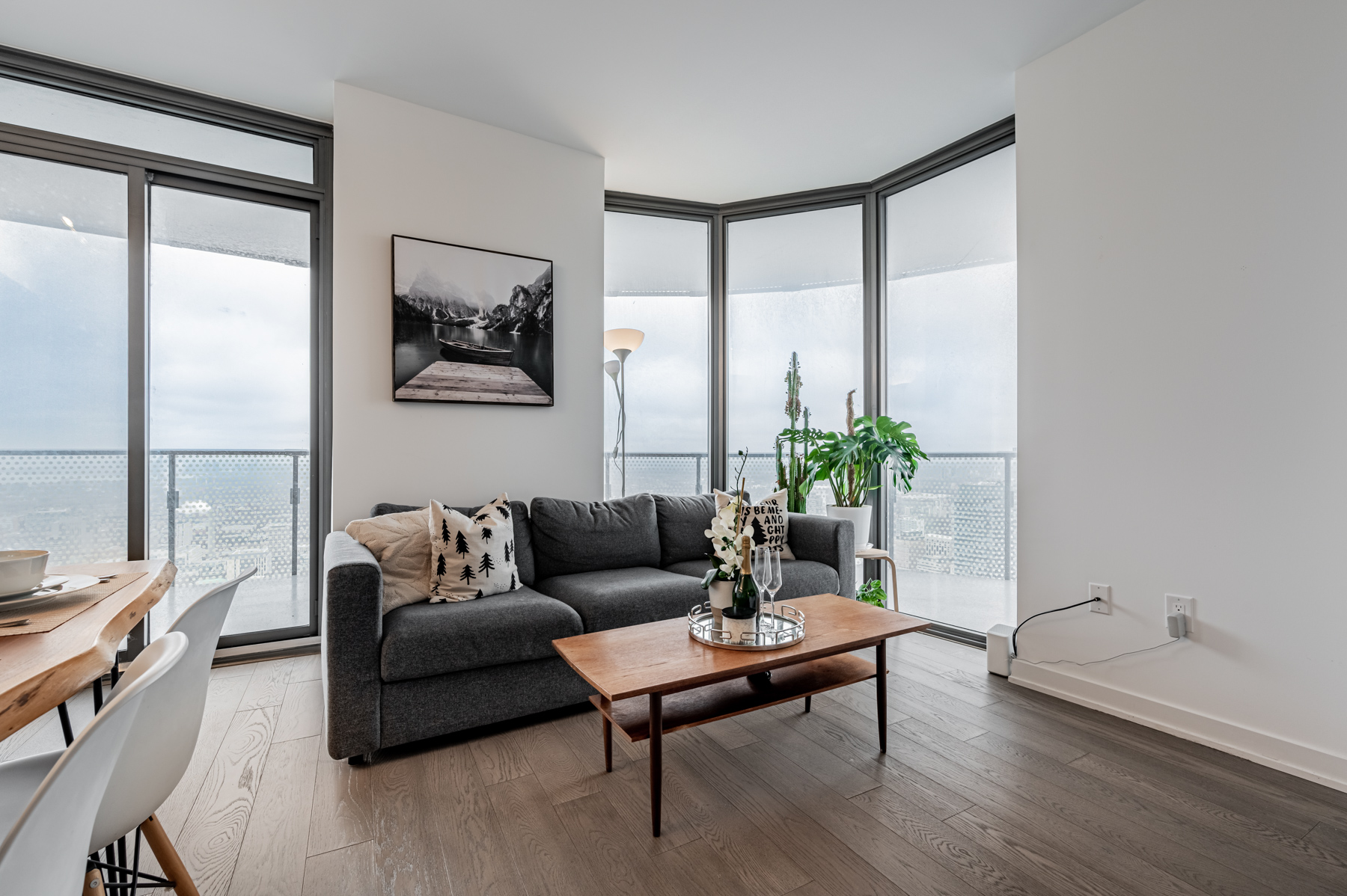 Condo living room with large windows on either side.