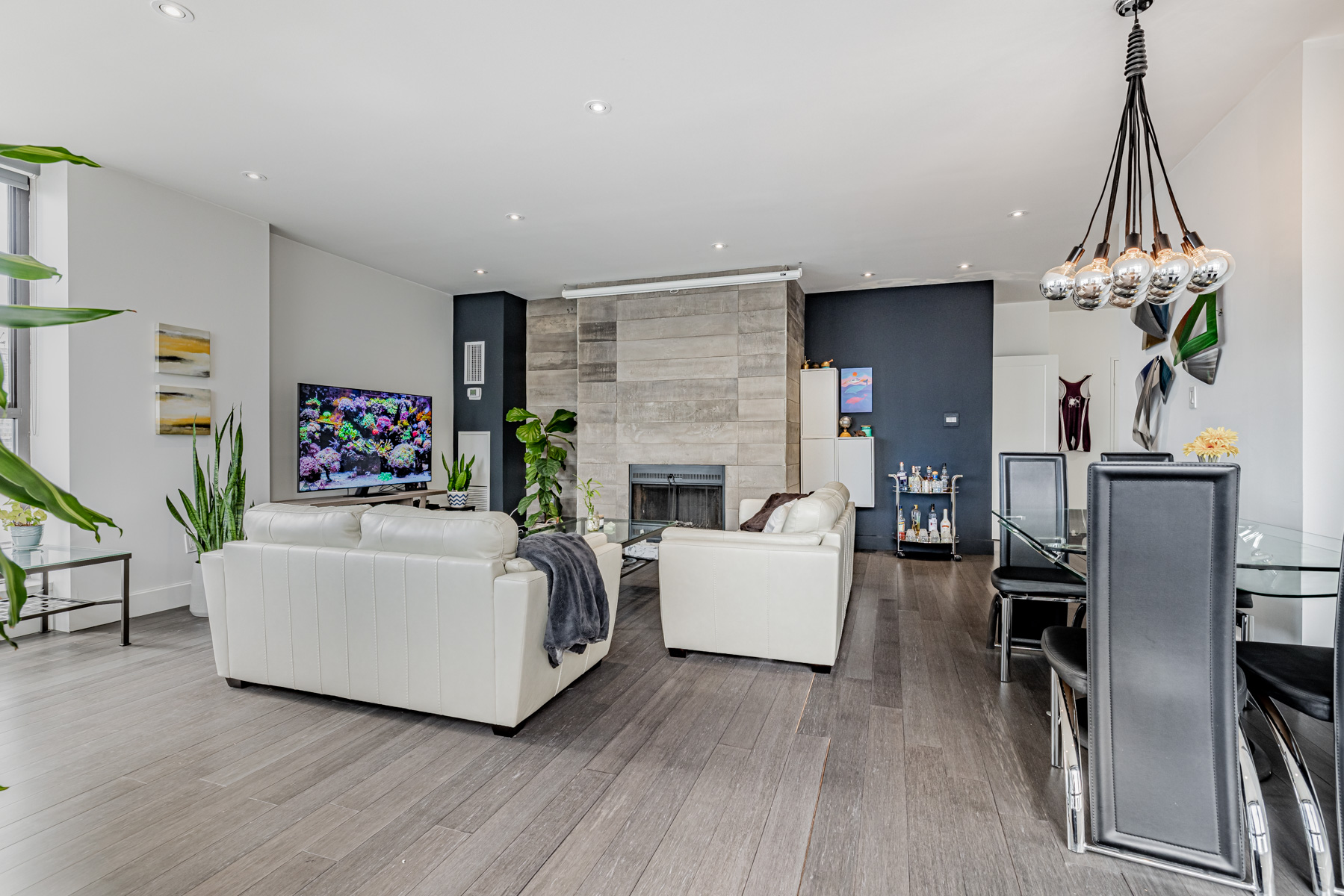 Smooth penthouse living room ceiling with pot-lights.