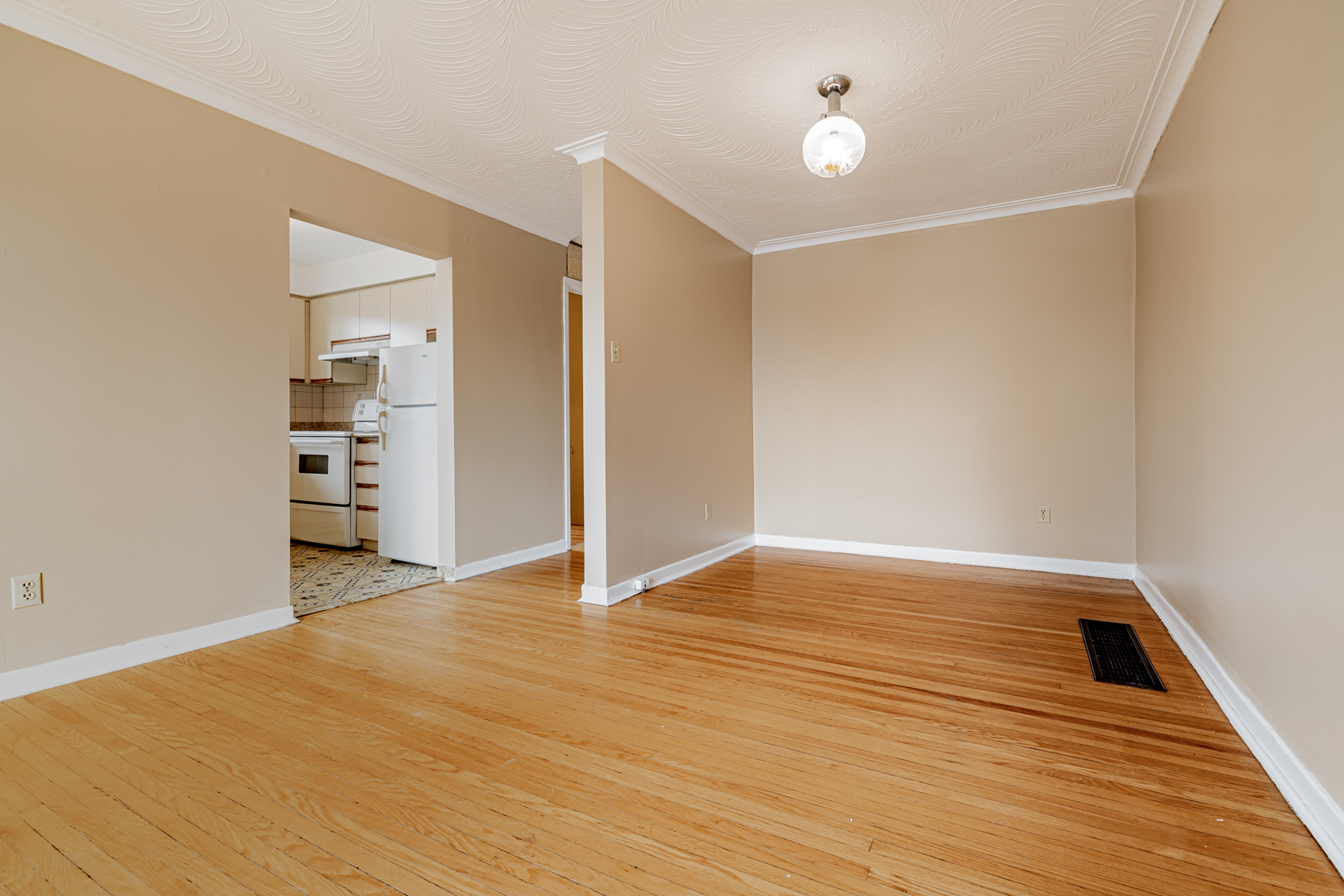 Empty dining room with LED light fixture.