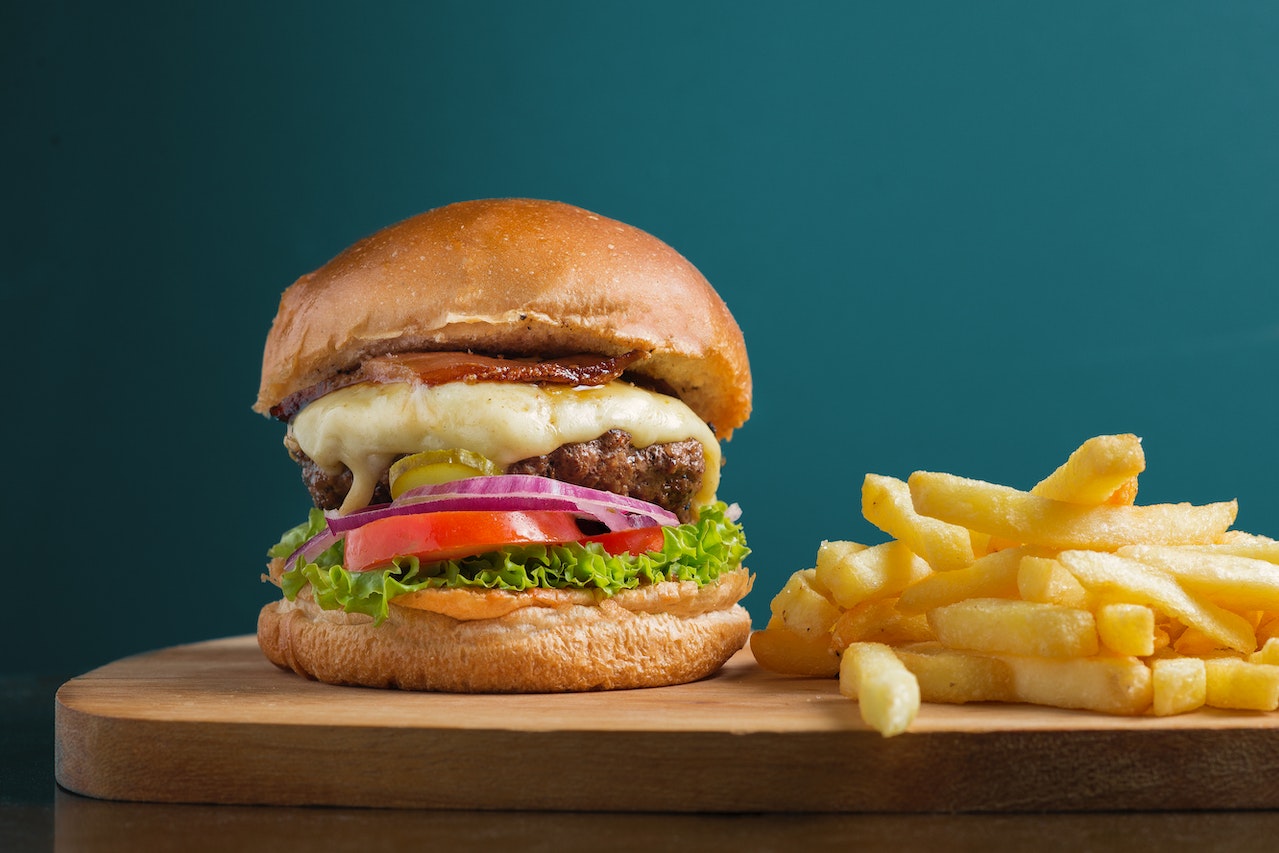 Photo of large hamburger and fries. 