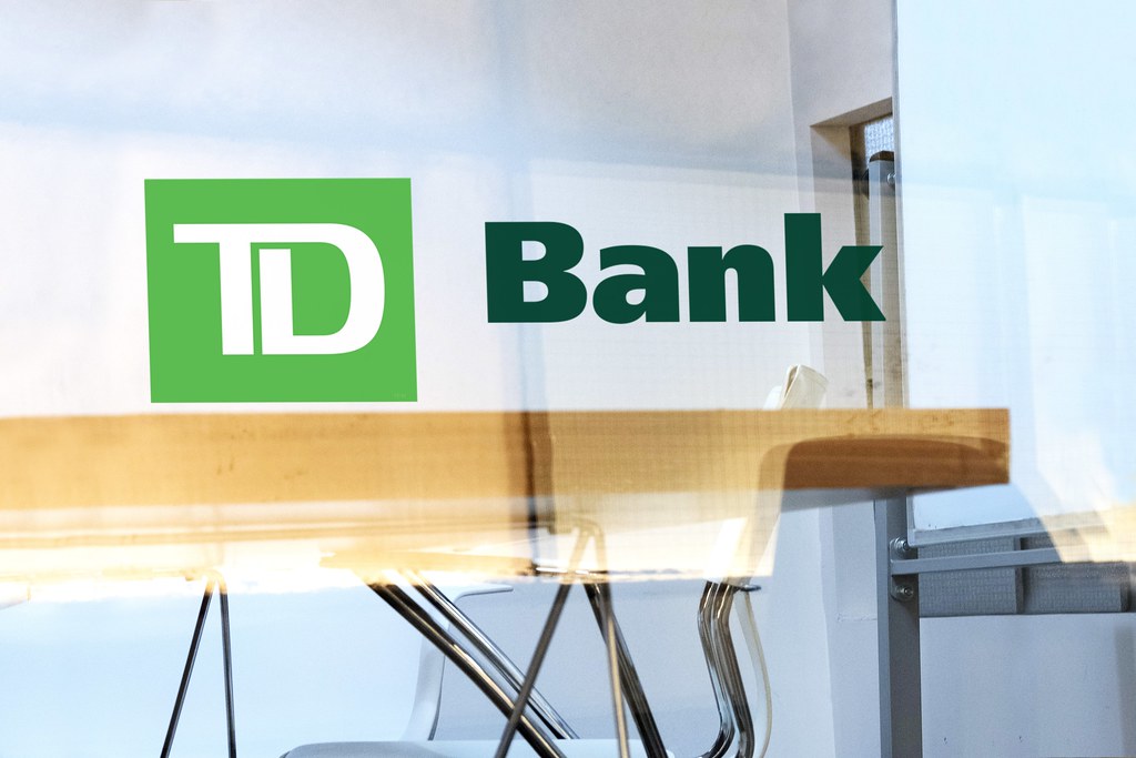 TD Bank logo on glass door at bank.