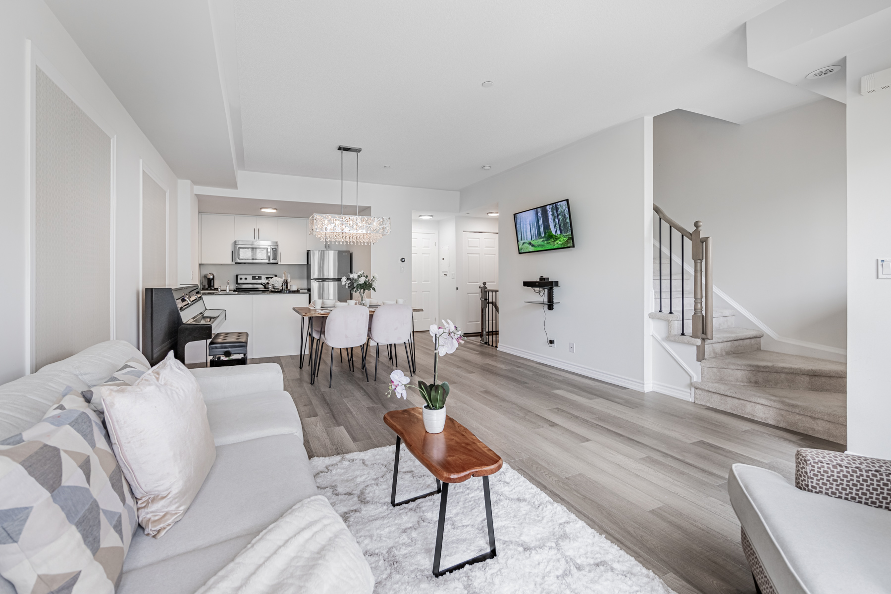 Open-concept living and dining room of 20 Carnation Ave Unit 42.