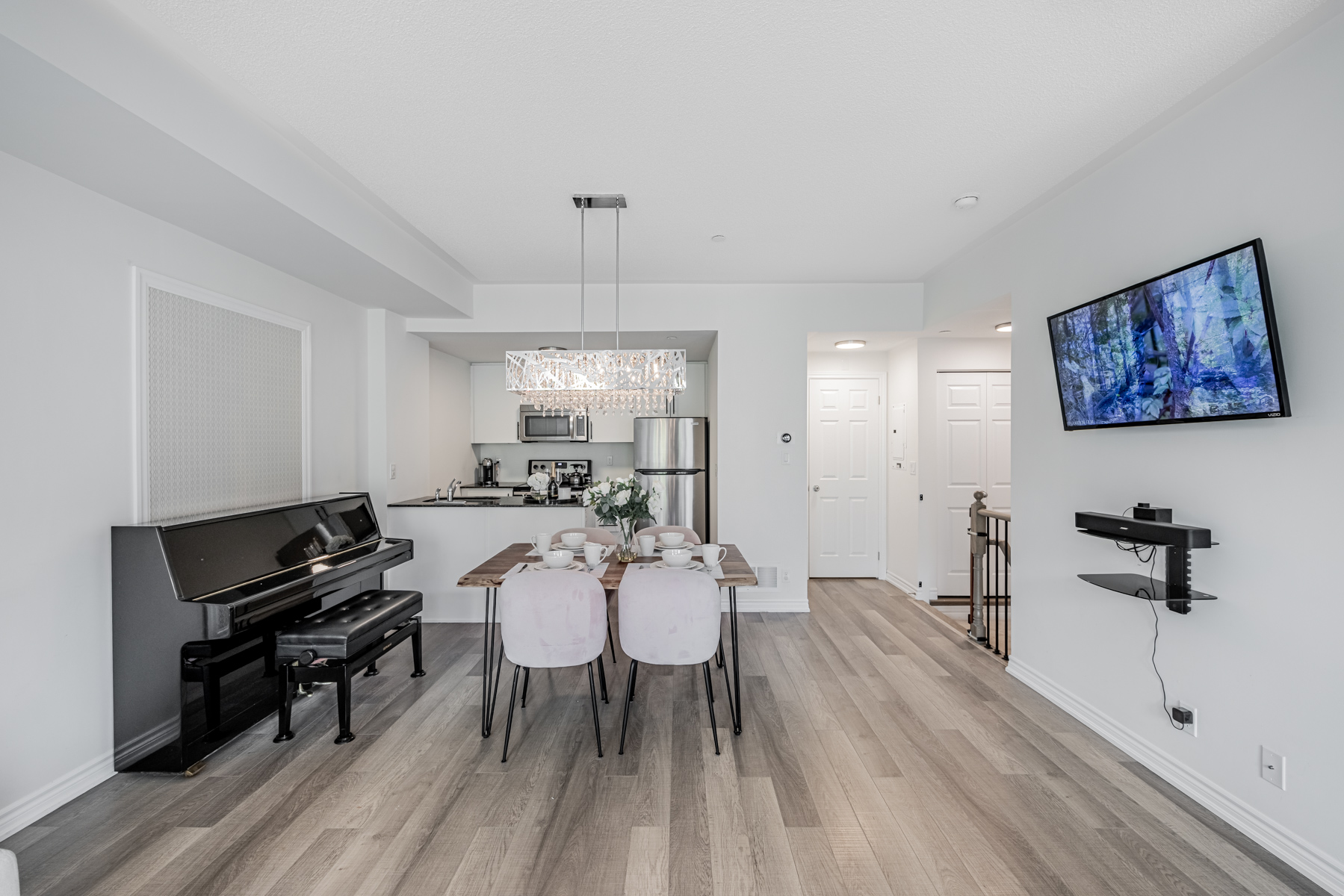 20 Carnation Ave Unit 42 dining room with piano to left and TV to right.