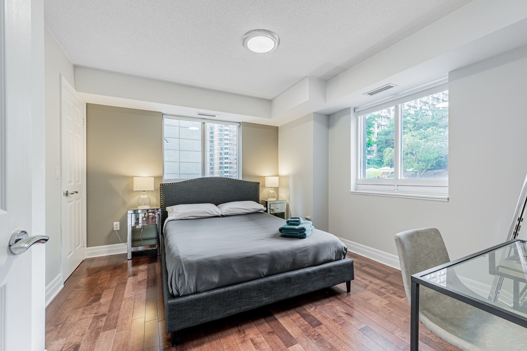 Large condo bedroom with bed, night stands and window – 35 Balmuto St Unit 401.