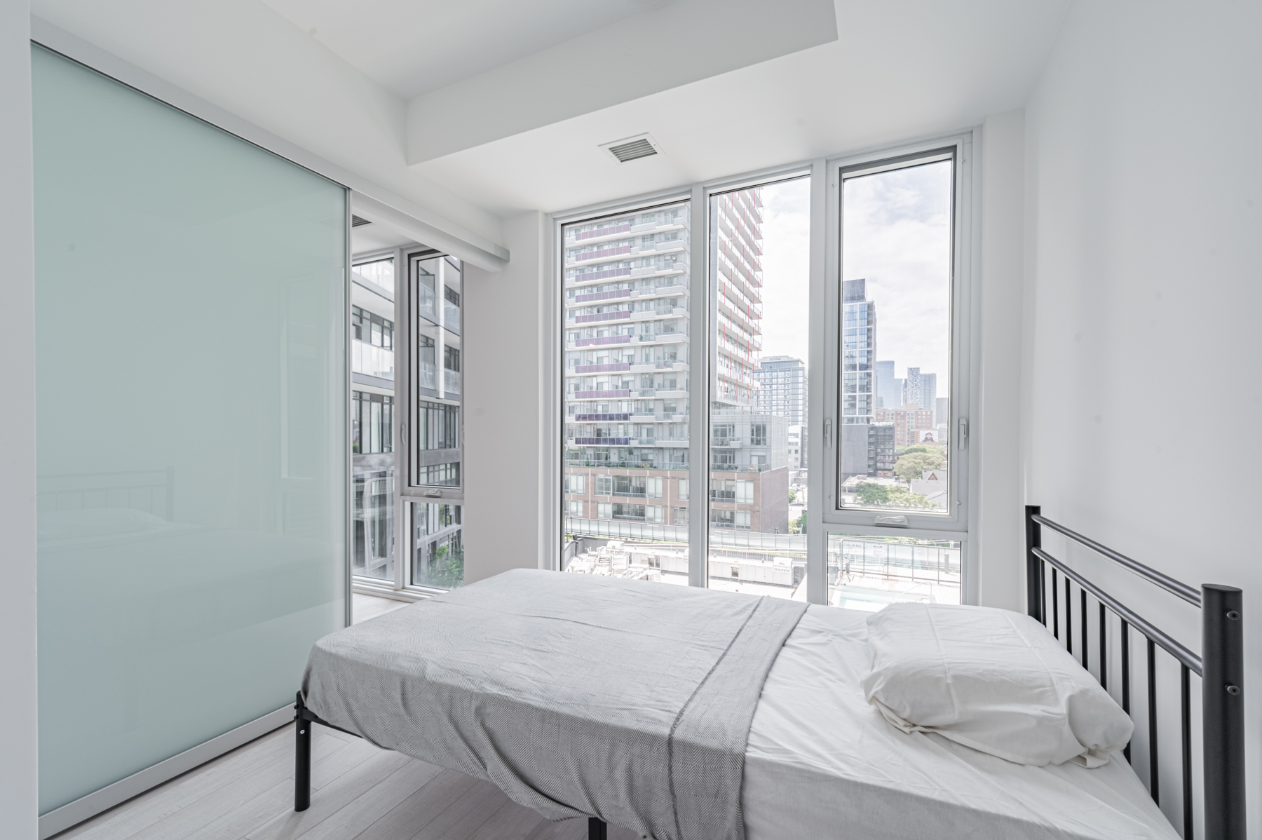 50 Power St Unit 618 second bedroom with large windows showing city view.