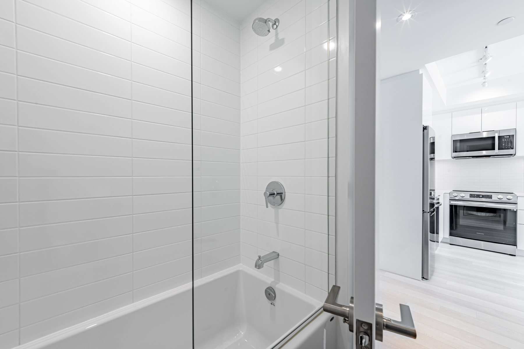 4-piece bathroom with soaker tub, shower and frame-less glass doors.