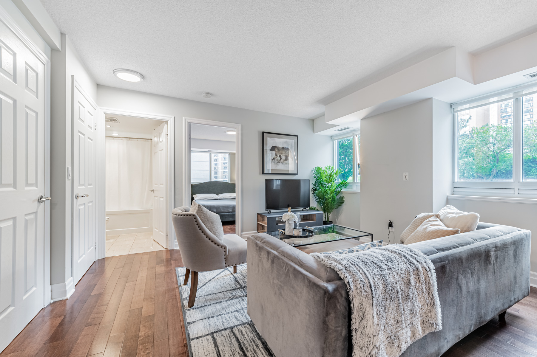 Sofa, TV and hardwood floors of 35 Balmuto St Unit 401 living room.