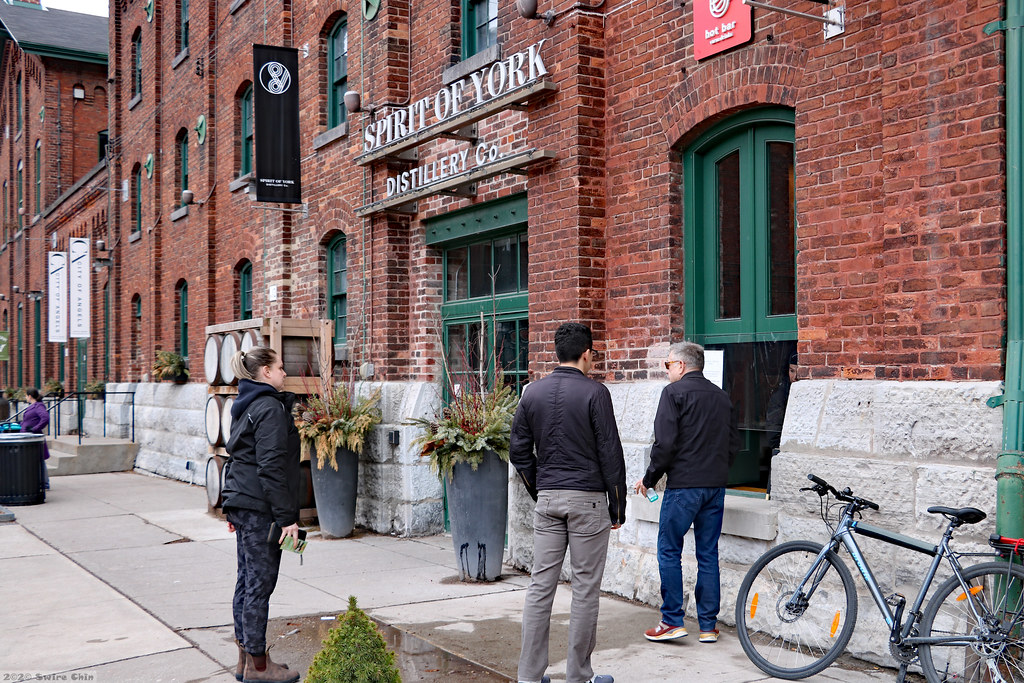 People outside Spirit of York Distillery building in Distillery District Toronto.