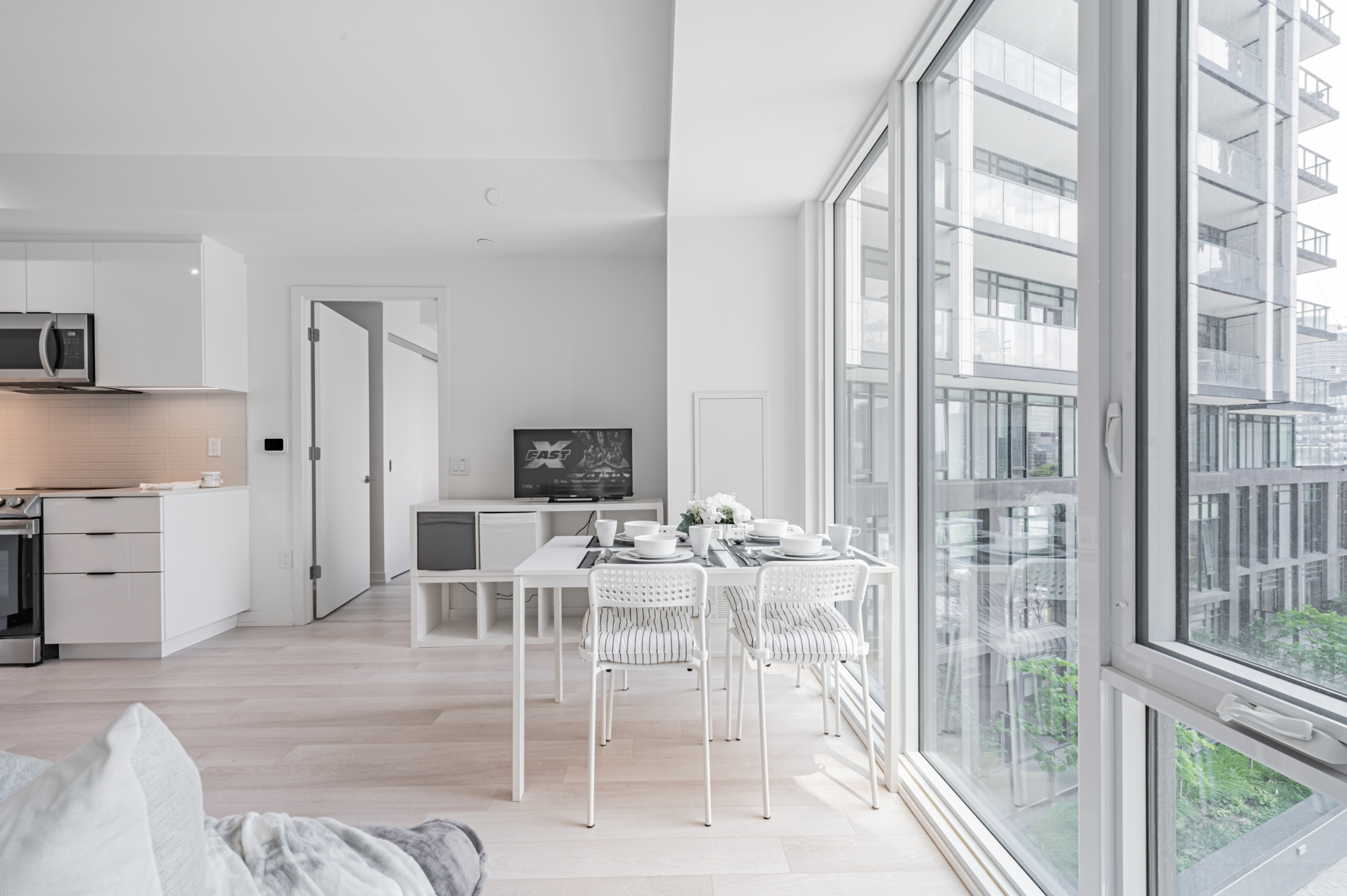 Light coloured condo dining room next to window. – 50 Power St Unit 618.