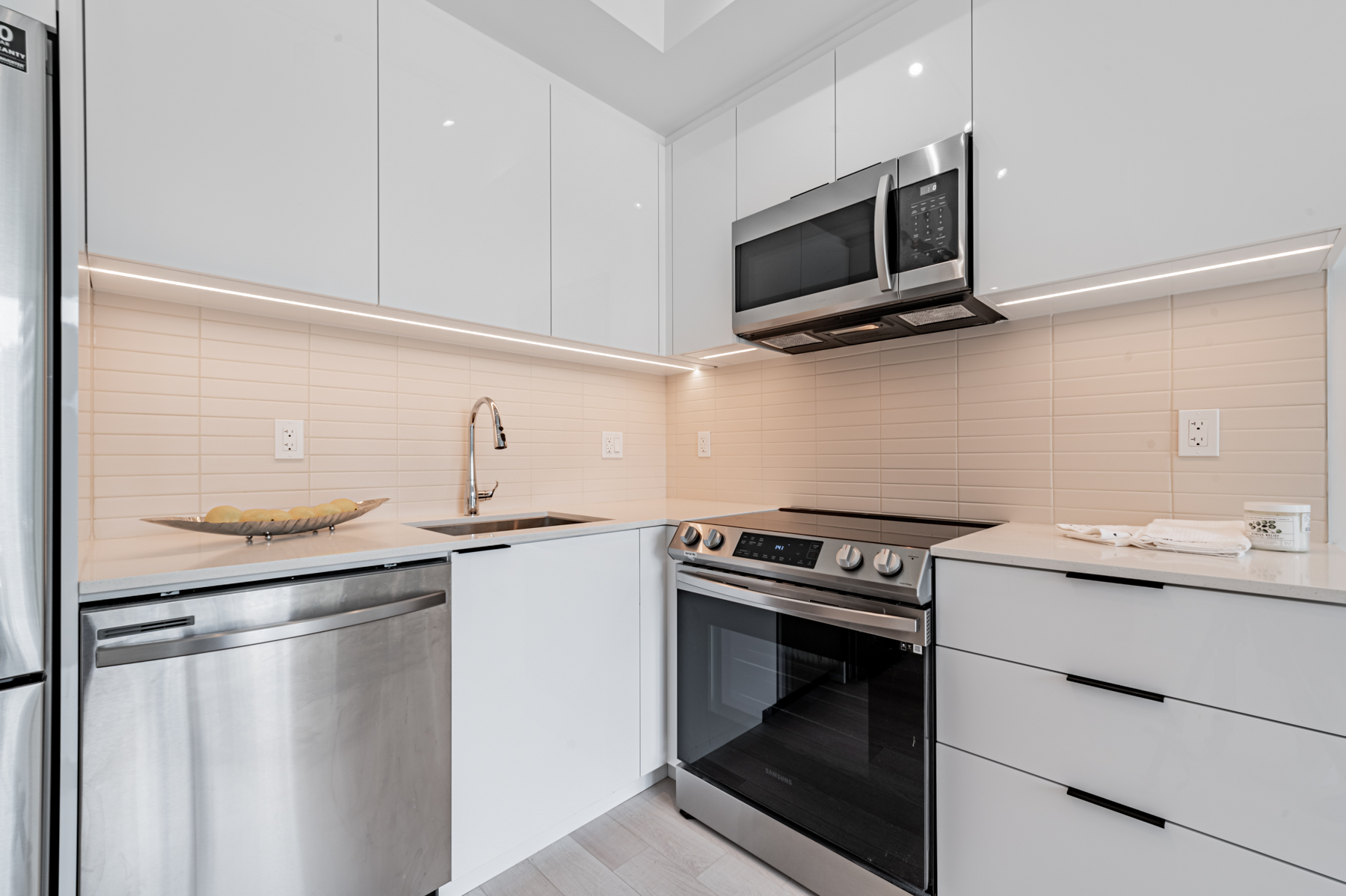 Condo kitchen with newly upgraded glossy white cabinets.