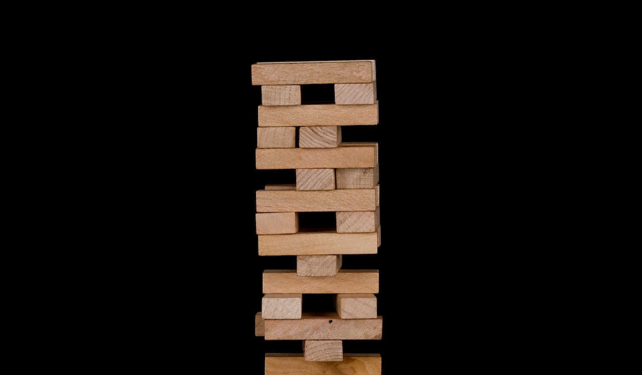 Jenga blocks on black background.