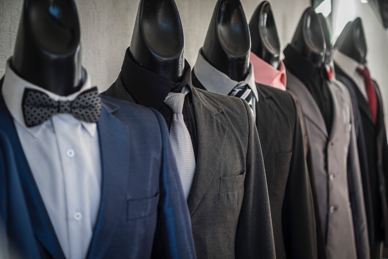 Multiple mannequins dressed in men's suits.