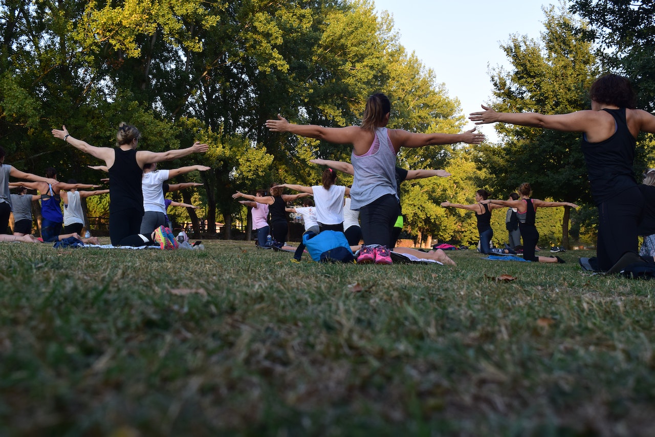 Outdoor yoga class on grass. 