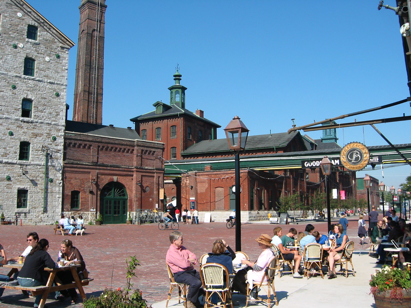People dining on outdoor patios in Distillery District in Toronto.