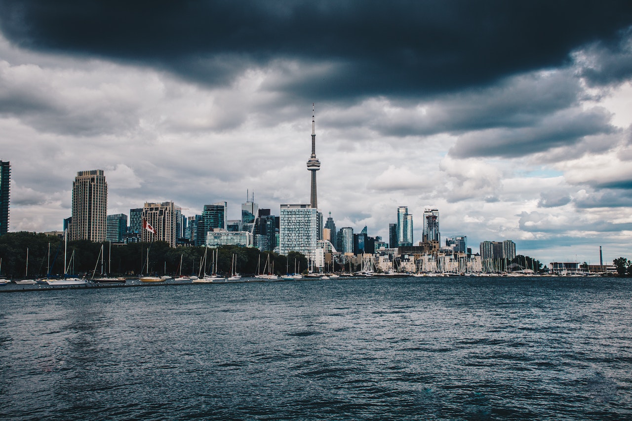 Toronto skyline with dark clouds to show impact of June 2023 interest rate hike. 