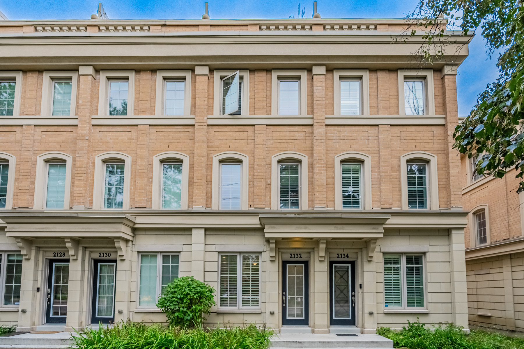 Front of 2132 Bayview Ave Unit 199, a 3-storey townhouse with red-brick and gray stone facade.