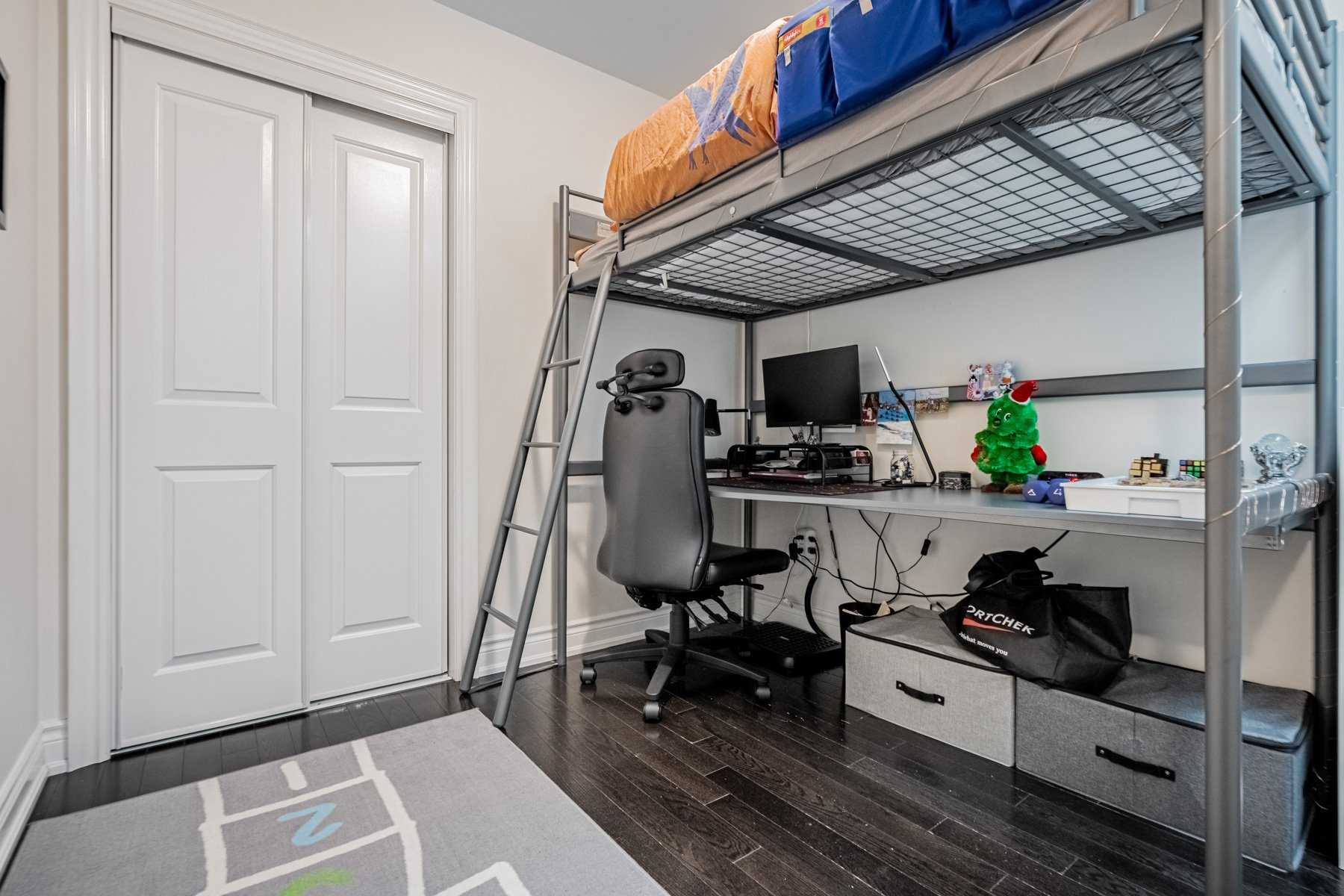 Double door closet next to storage loft bed.