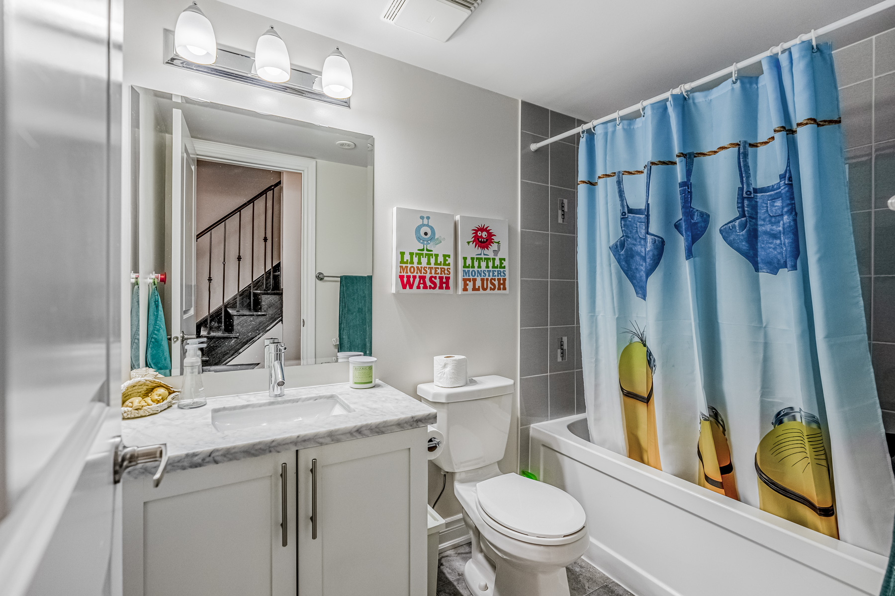 2132 Bayview Ave Unit 199 bathroom with Minions shower curtain and kid-friendly signs.