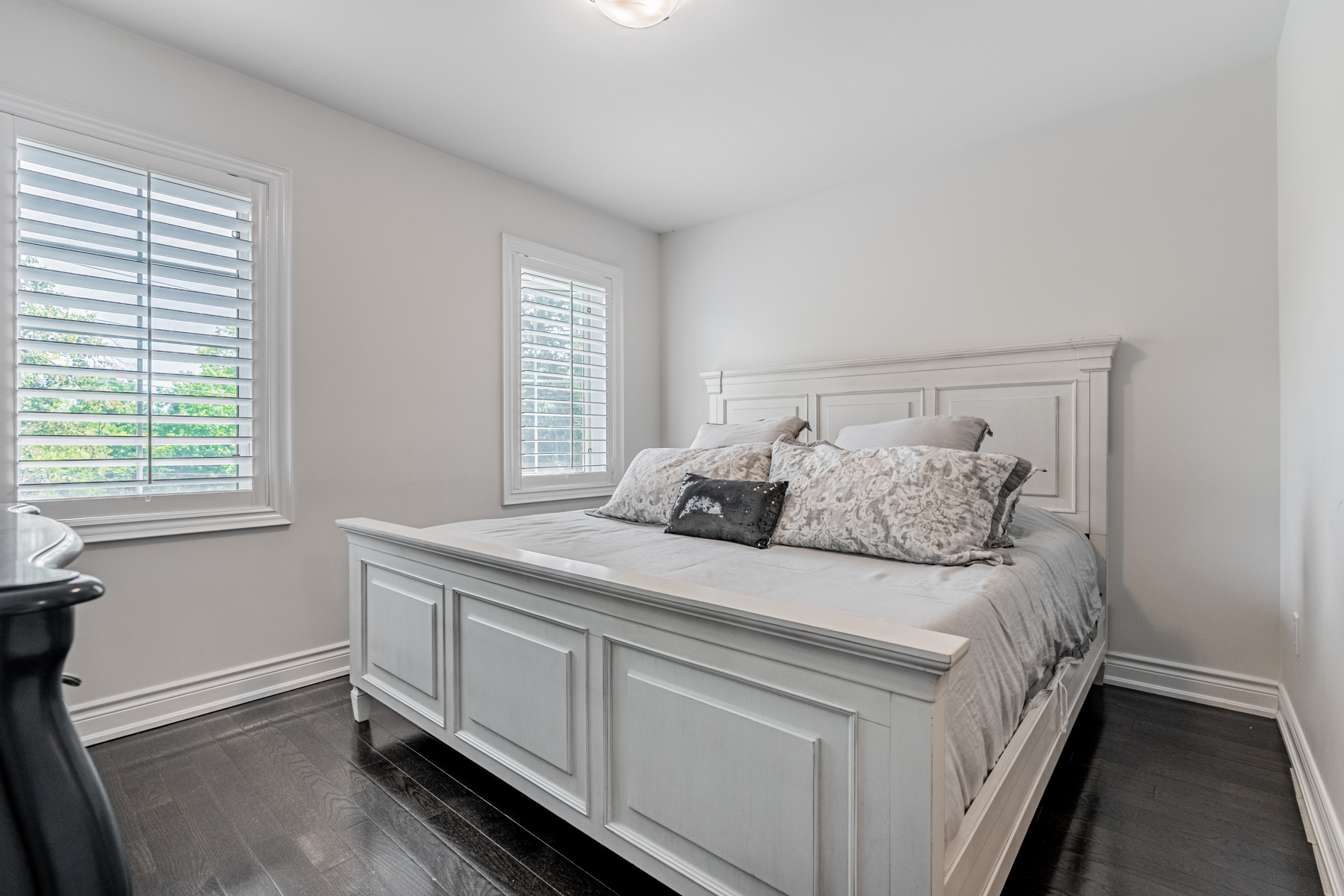 Large primary bedroom with dark hardwood floors – 2132 Bayview Ave Unit 199.