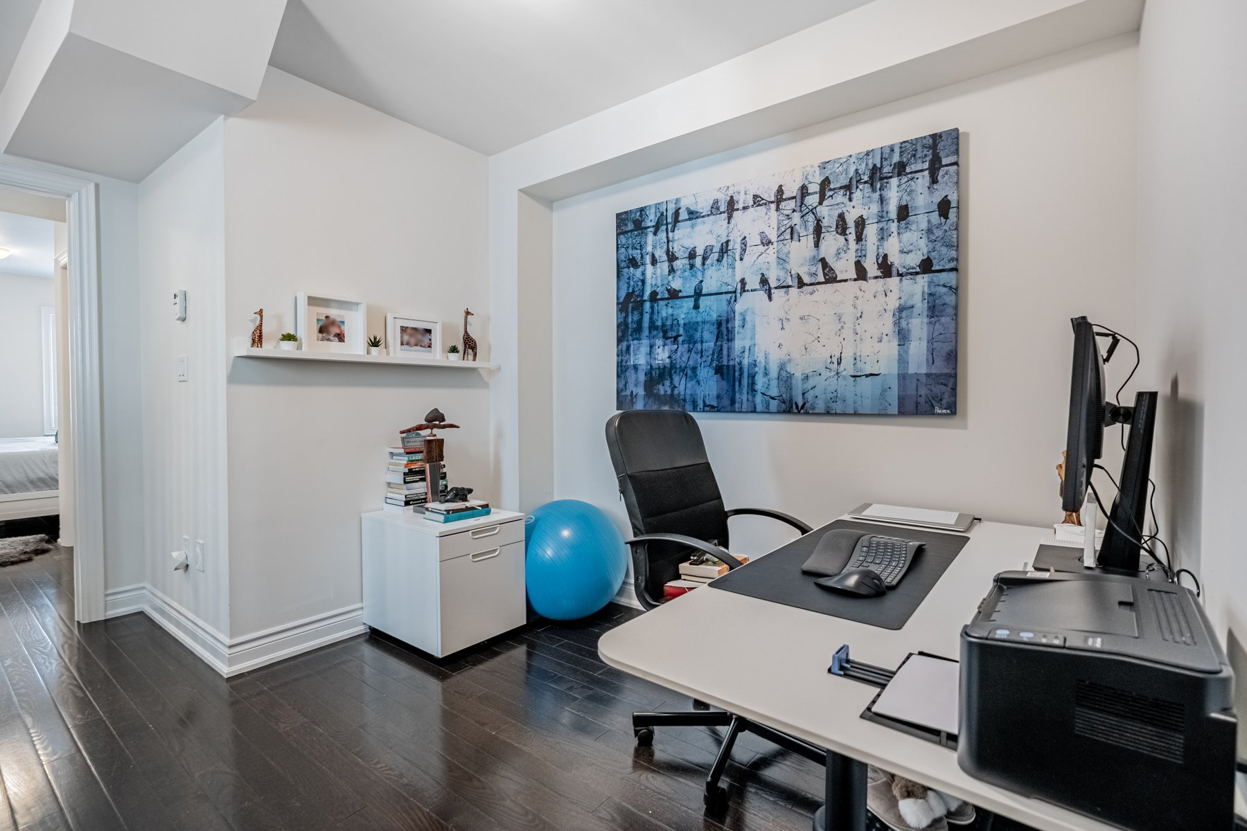 Den with hardwood floors and LED lights being used as home office.