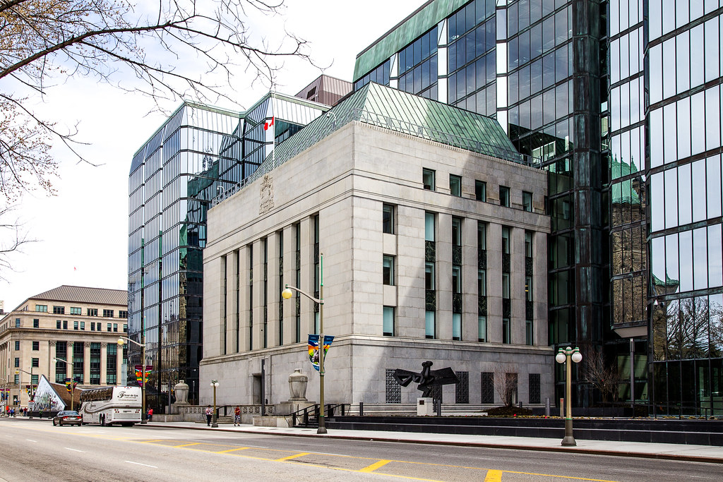 Gray concrete exterior of Bank of Canada building to show impact of interest rates on August 2023 market.