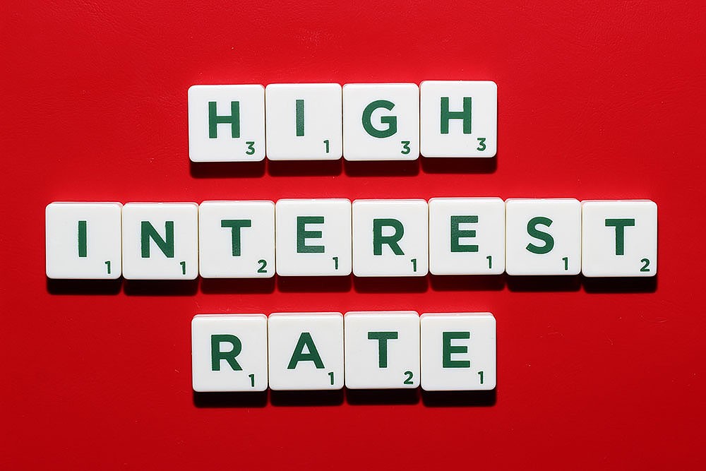 White tiles spelling out words “High Interest Rate.”