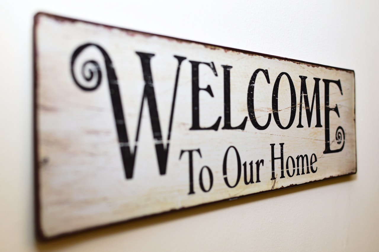 Closeup of sign saying “Welcome to Our Home.”