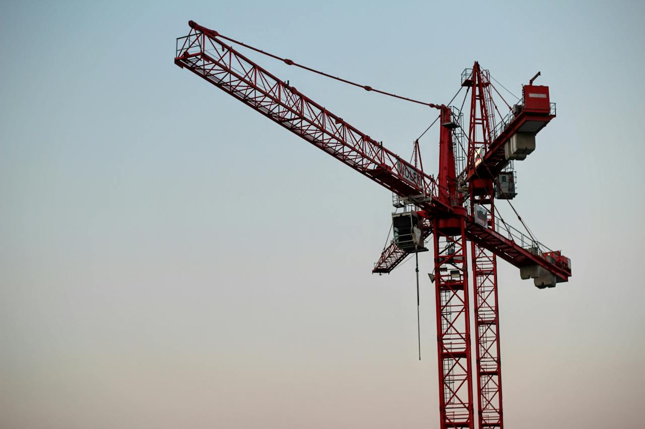 Large red construction crane to show need to build more homes. 